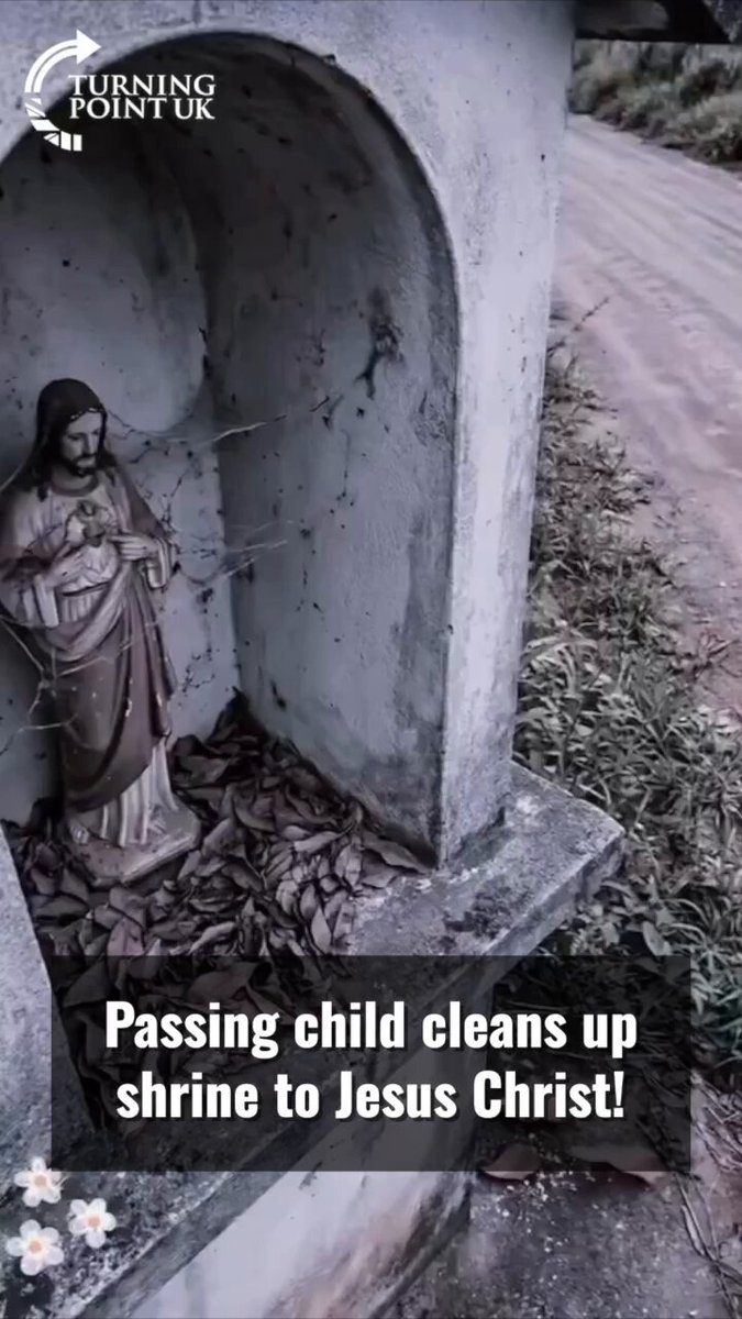 Passing child cleans up shrine to Jesus Christ!