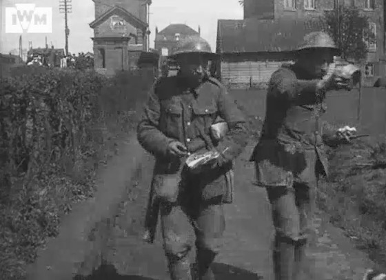 British soldiers pose with a dog in the Béthune area on the Western Front, April 1918, during the German spring offensive. Film: IWM186