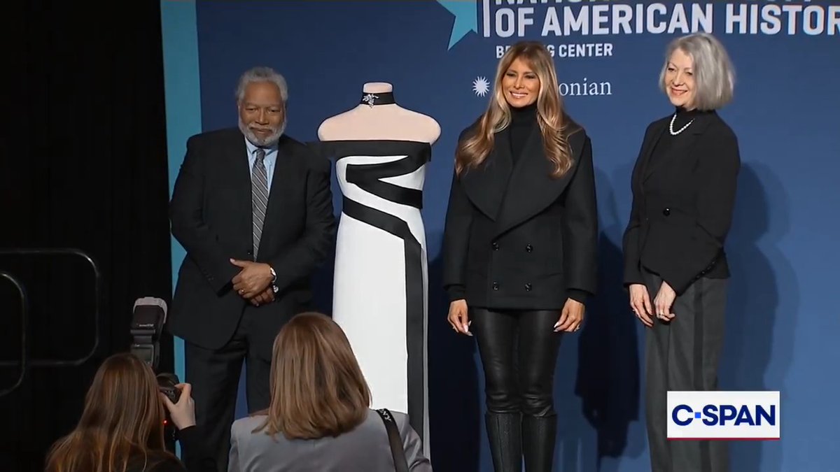 First Lady Melania Trump poses for pictures during a presentation ceremony adding her 2025 inaugural ball gown to the Smithsonian National Museum of American History.
