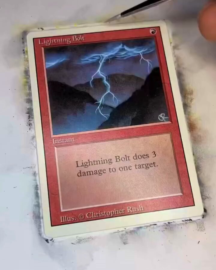 Someone just paid $16,300 for this hand-painted LEGO Magic: The Gathering card 🤯 Artist Eric Klug is known for hand-painting custom Magic: The Gathering cards, transforming already iconic pieces into one-of-one works of art. Instead of just painting a LEGO-style “Lightning Bolt,” he built a real-life LEGO mockup of the scene first, brick frame, skeleton minifigure, tiny parrot, and all, then used it as the reference for the final card. The finished piece looks like a LEGO diorama, but it is entirely hand-painted onto an actual MTG card. (via Eric Klug)