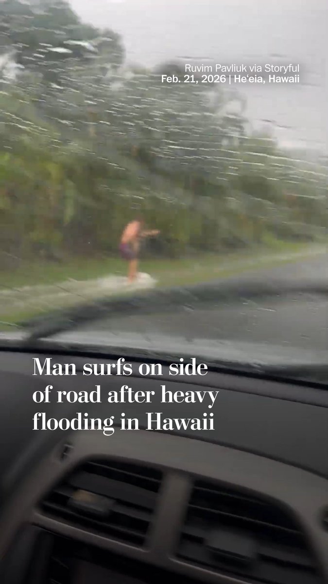 A surfer glided through floodwater on the side of the street in Heสปeia, Hawaii, on Feb. 21, according to footage recorded by Ruvim Pavliuk. The National Weather Service issued a flash flood warning for much of the area during the storm, warning people not to drive in the flooded areas.