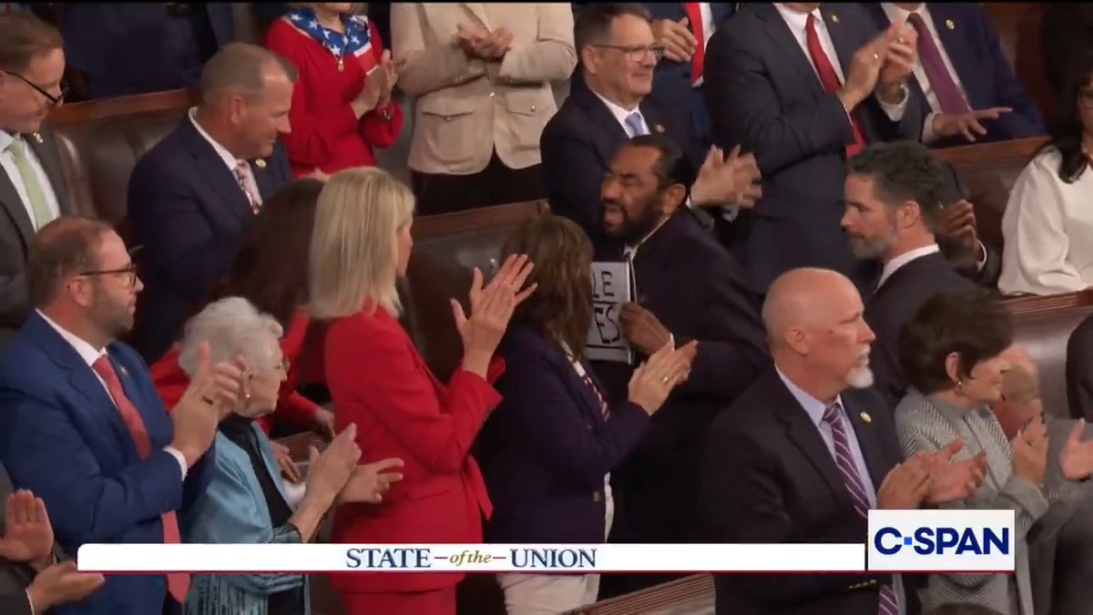 .U.S. Representative Al Green is escorted out of the House Chamber holding a sign reading "Black People Aren't Apes." #SOTU #SOTU2026