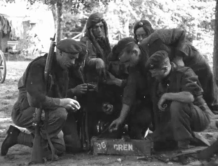 Men serving with No. 3 Mortar Platoon, No. 47 (Royal Marine) Commando prepare to go on patrol in the Orne bridgehead, Normandy, 4 August 1944. Film: IWM A70 113-9