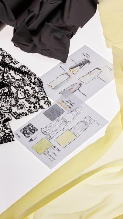 Recomposed into a fluid entity. The logic behind the design remains open, awaiting interpretation with every wear. A duchesse panel featuring flat pleats; an embroidered crepe panel; crystals mounted entirely by hand; ruffles layered over it. 27 hours, assembled element by element. Light and semi-transparent lace; architectural pleats; hand-worked anchoring points; gathered, hand-applied ruffles. 19 hours, entirely by hand. Discover more via: #PradaSS26 #Prada