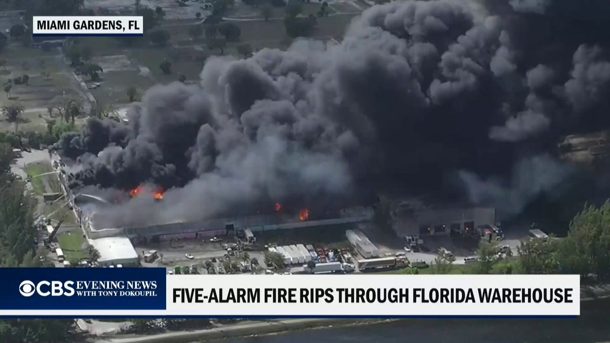 Crews are battling a massive warehouse fire near Miami, with helicopters dropping water as thick black smoke pours from the building. No injuries have been reported and officials are urging the public to stay away from the area.