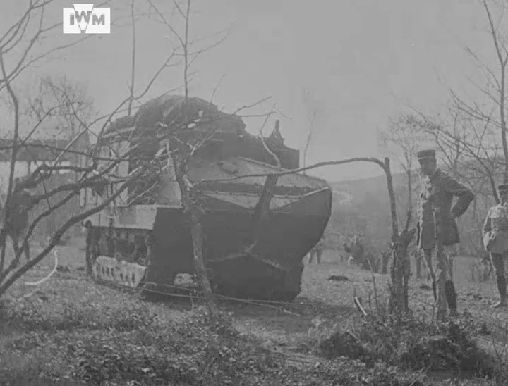 French soldiers watch as a Schneider CA1 demonstrates its ability to push over small trees, filmed on the Western Front, April 1918. Film: IWM IWM 508-92