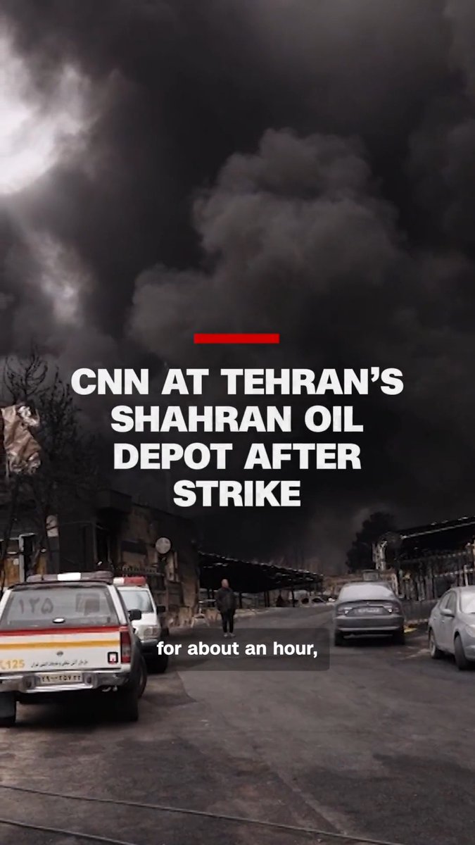 CNN's Frederik Pleitgen reports from Tehran's Shahran oil depot, where thick black smoke rises behind him after a strike hit the facility. Iranian state media said fuel and oil storage tanks in several areas of the capital were targeted in Israeli and US strikes. CNN operates in Iran only with government permission.