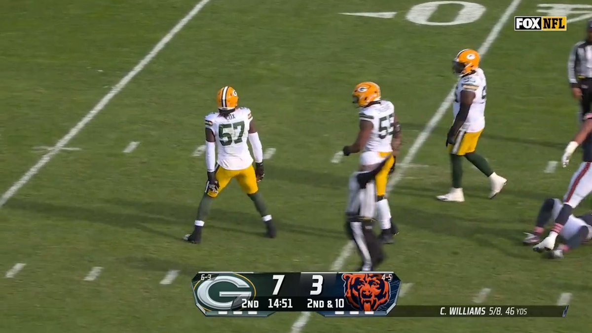 Caleb Williams rolling right into a Cox sack.