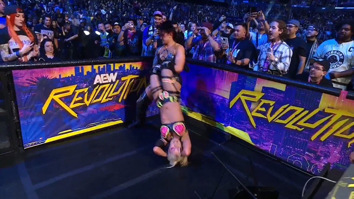 .@CallMeKrisStat is brutalizing @Toxic_Thekla at ringside! Watch #AEWRevolution LIVE on PPV!