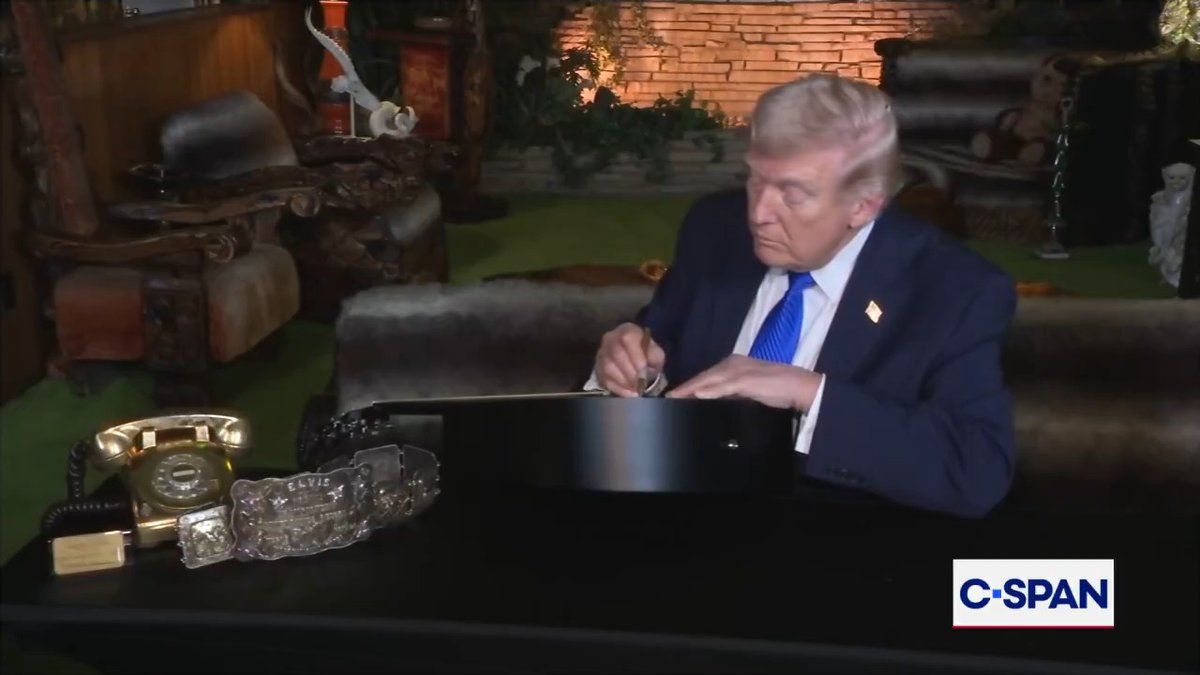 President Trump signs replica guitar at Graceland, the home of Elvis Presley, in Memphis, TN.