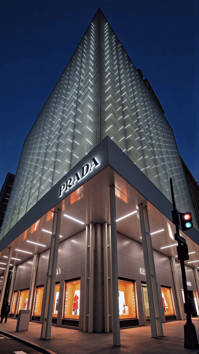 Prada presents the facade of its Fifth Avenue building in New York City. Industrial and refined, functional and decorative, familiar and uncanny: dualities emerge through shifting layers of light and structure. What is seen is never fixed, but constantly evolving. Discover more: #Prada