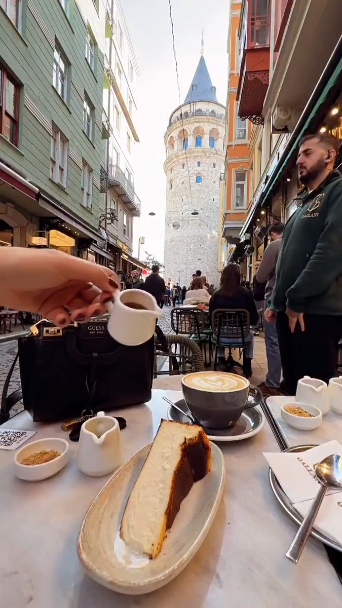 Cappuccino and San Sebastian cheesecake overlooking the Galata Tower in Istanbul. Good morning ☕️