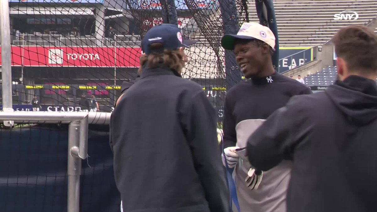 Jazz Chisholm Jr. and Jose Caballero check out Jack Hughes' gold medal, while Hughes checks out Chisholm's bat