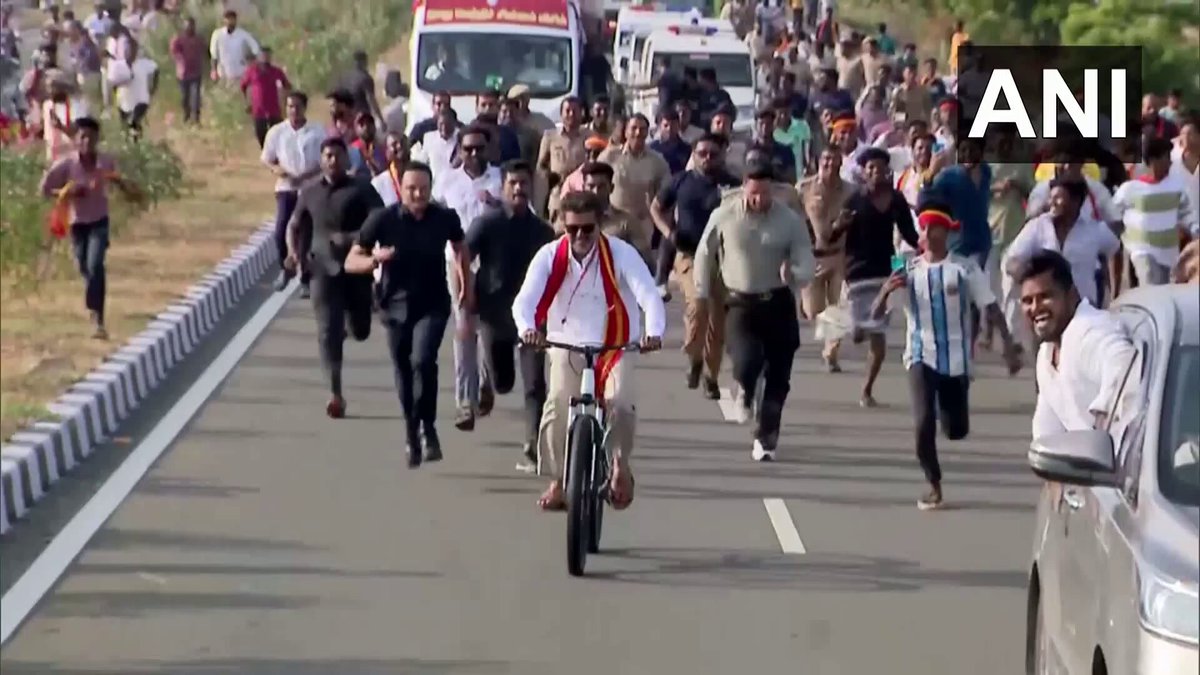 #WATCH | Tamil Nadu | Tamilaga Vettri Kazhagam (TVK) chief and actor Vijay, candidate from Perambur and Tiruchirappalli East constituencies, rides a cycle during his election campaign rally in Kanniyakumari. (Source: TVK)