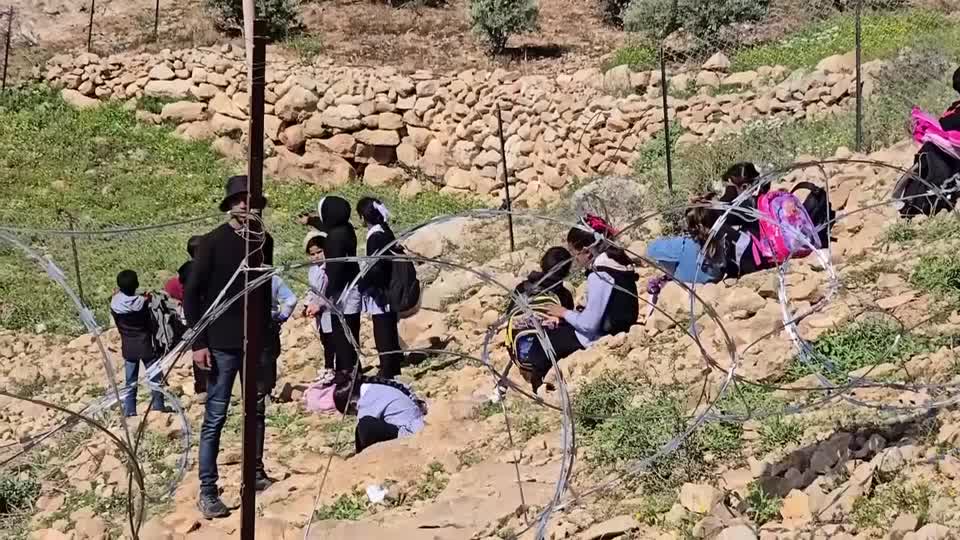 Dozens of Palestinian children have been unable to go to school in the Israeli-occupied West Bank this week because of a barbed-wire fence villagers say was put up by Jewish settlers across the path they normally use