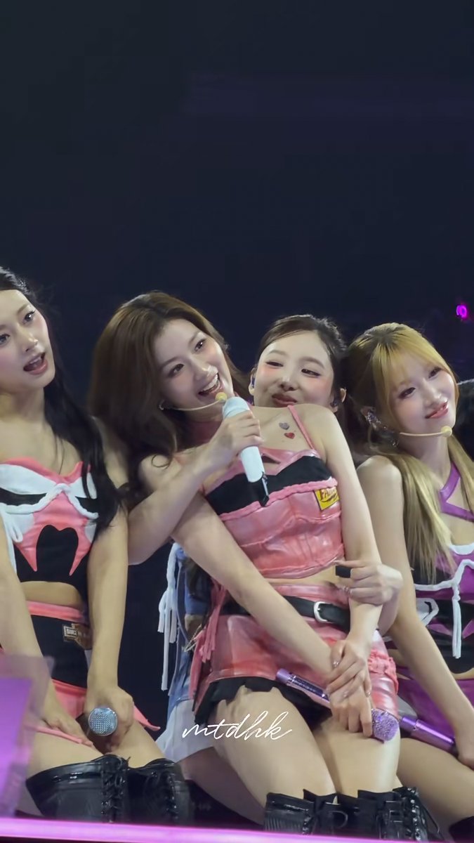 Nayeon looks so happy with Sana on her lap and letting her sing into her mic