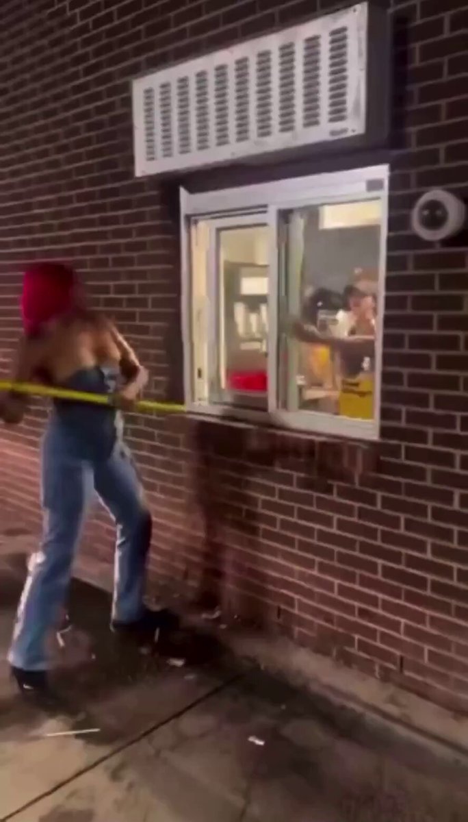 Lady loses it while waiting for her food and tries to break the drive thru window