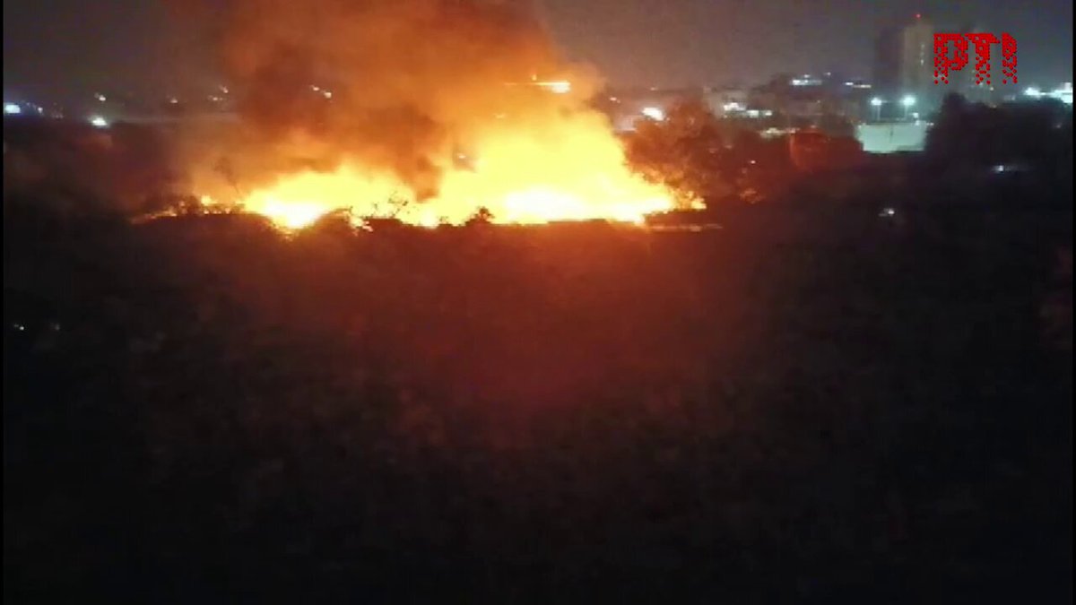 VIDEO | Gurugram: Fire breaks out in several jhuggis near Sikanderpur Metro. Further details awaited. (Full video available on PTI Videos -