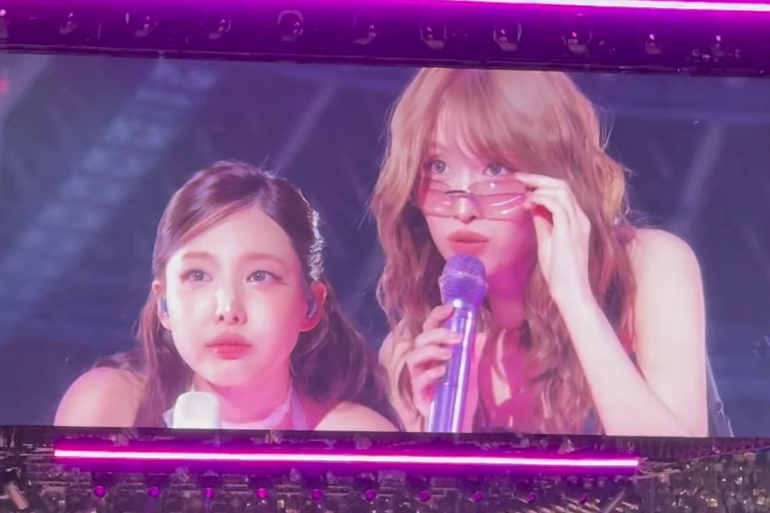 TWICE struggling to read the message on the fan banners 😭