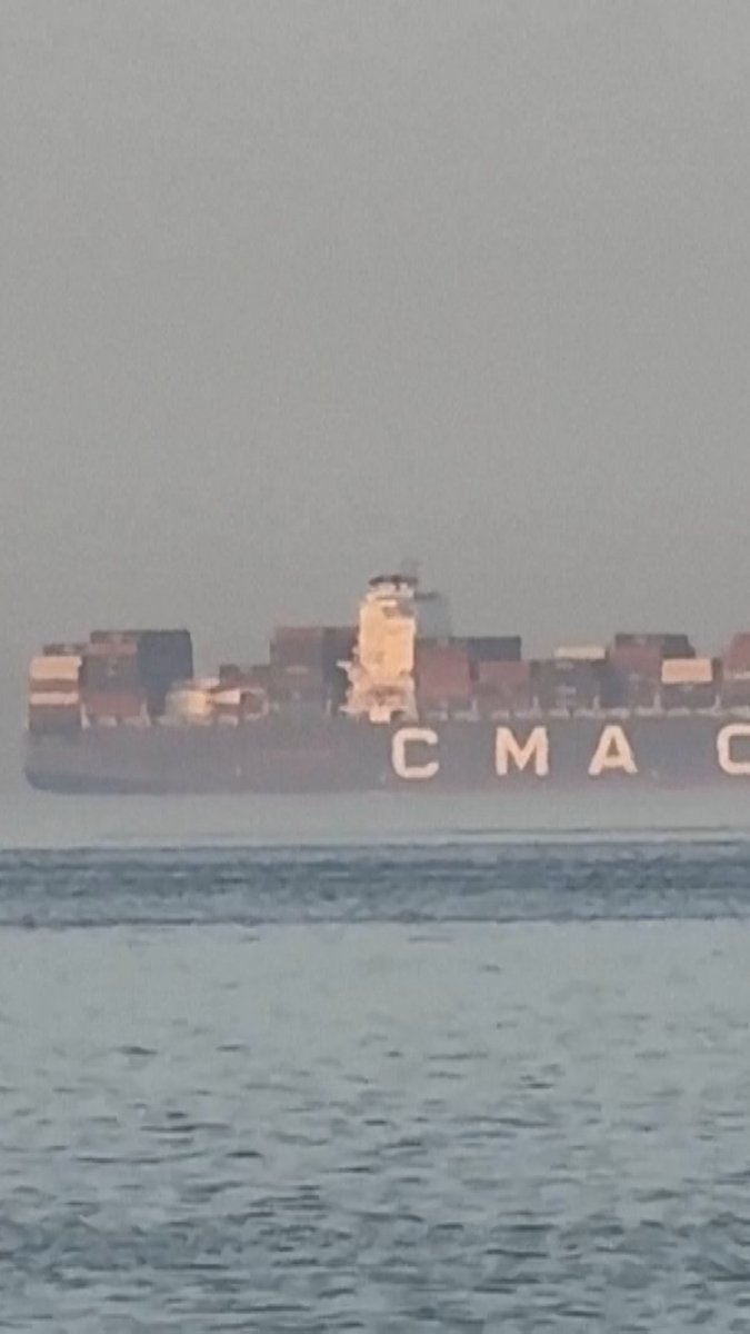 Ships wait in the Strait of Hormuz where a standoff remains between the U.S. and Iran. Iran has restricted movement through the strait, and the U.S. has enforced a blockade of Iranian ports.