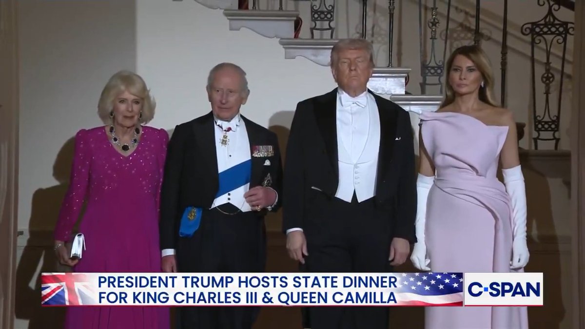 President Trump and First Lady Melania Trump, alongside King Charles III and Queen Camilla, descend the staircase to the White House's East Room for the state dinner.
