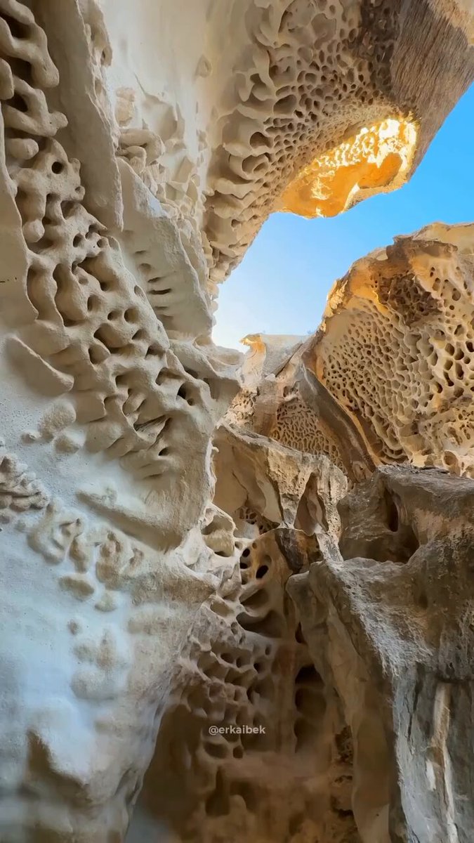 The Yrbyktu-Sai Canyon in Kazakhstan is a natural wonder formed by the erosion of limestone cliffs by water and wind over approximately 50 million years.