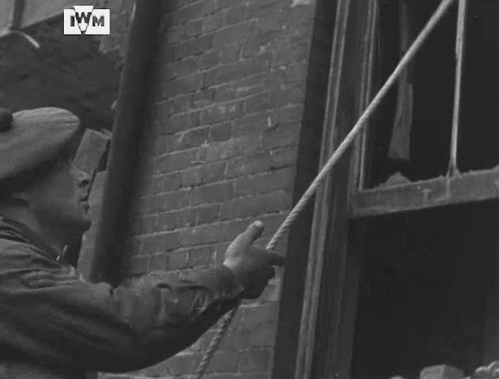 A soldier of 1st Battalion Black Watch grapples his way up to a window during street fighting practice, possibly at Limehouse, London, 1944. Find the full footage here: Film: IWM A70 14-2