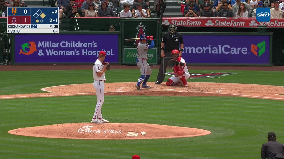 Angels first baseman Nolan Schanuel throws his glove to pitcher Jack Kochanowicz at first base to get the out