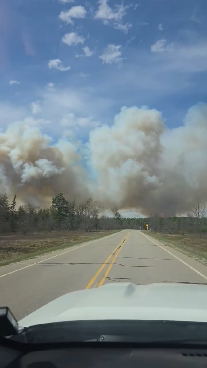 ⚠️MASSIVE wildfire ongoing now near Mio. We’re unsure if there are structures involved, or just wildfire related (or both), but this was speculated to be started by a downed power line from high winds. Evacuations are underway along camp 10 road west of Mio! MULTIPLE fires are breaking out across northern Michigan. Scanner feeds across many counties indicate high volume of fire calls. 📸Rylan S. - May 4th, 2026