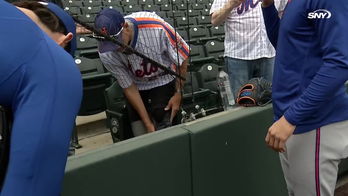 Tobias Myers, Clay Holmes, and Austin Warren sign the prosthetic leg of a Mets fan in Colorado