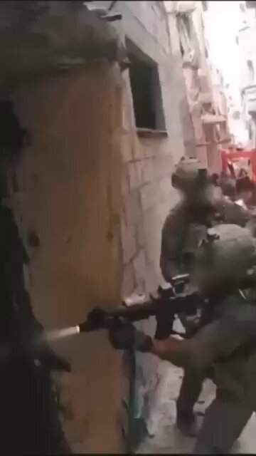 IDF Soldiers Engage Hamas in Brutal CQB Fight Bodycam footage shows IDF soldiers fighting through a narrow, debris-filled alley before breaching a damaged building during an intense close-quarters battle with Hamas militants. Grenades are used to clear the entry before the team pushes inside under heavy tension, moving room to room with weapon lights through dust and rubble. The operation ends with Israeli troops confirming two militants killed. #Israel