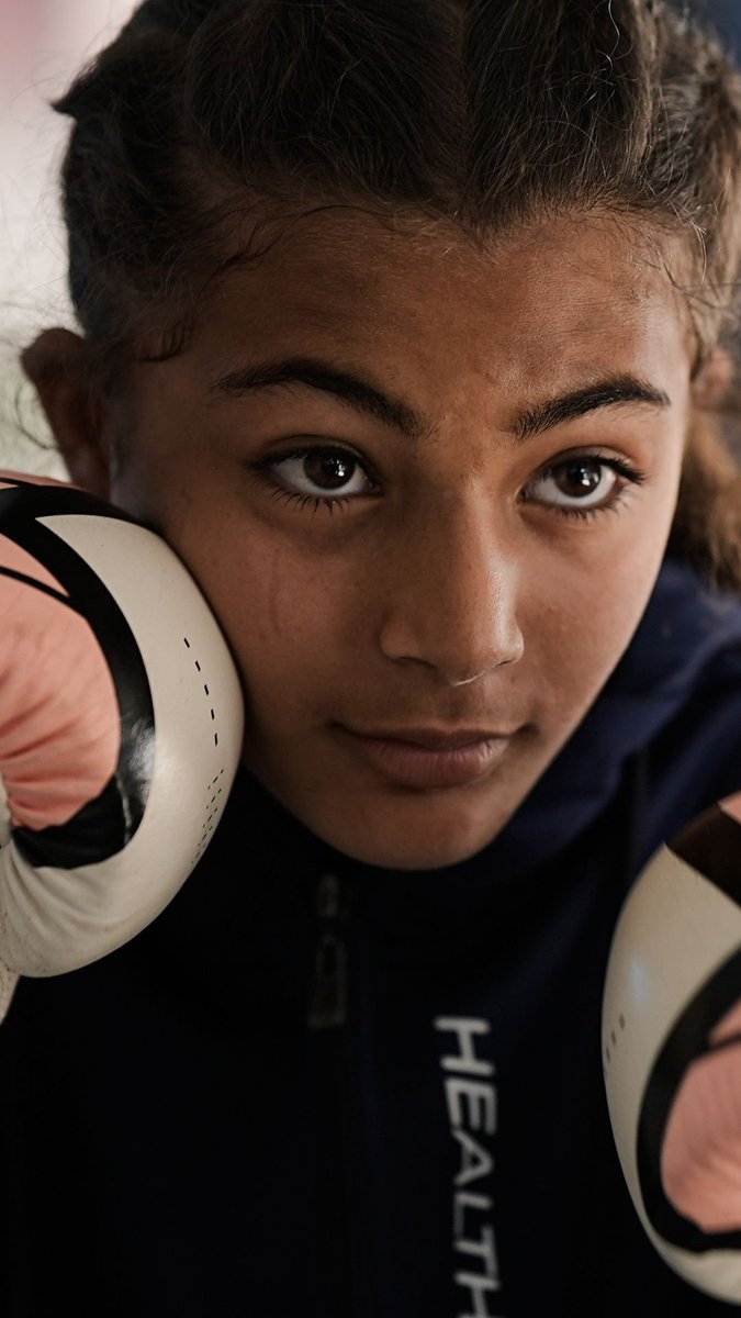 Under the blazing sun in Gaza’s Muwasi area of Khan Younis, girls of different ages line up between rows of tents to practice boxing, throwing punches at worn punching bags and makeshift training pads fashioned from plastic poles and padded tarps.