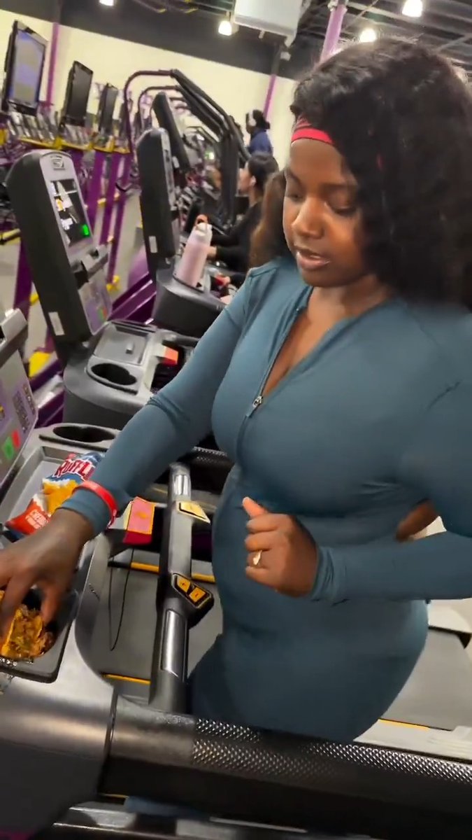 High calorie ratchet woman with her back fat rolls exposed pours food into the cup holder at a Planet Fitness gym treadmill in Indianapolis. I detest Planet Fitness (video for another day...) but imagine being the employee that has to clean this slop up 🤨 Workout accordingly... #CityLife #3rdWorld #crime #decay #obesity #food #PlanetFitness #indianapolis #indy #weave #diversity #19th #gross #urban #democrats #fitness