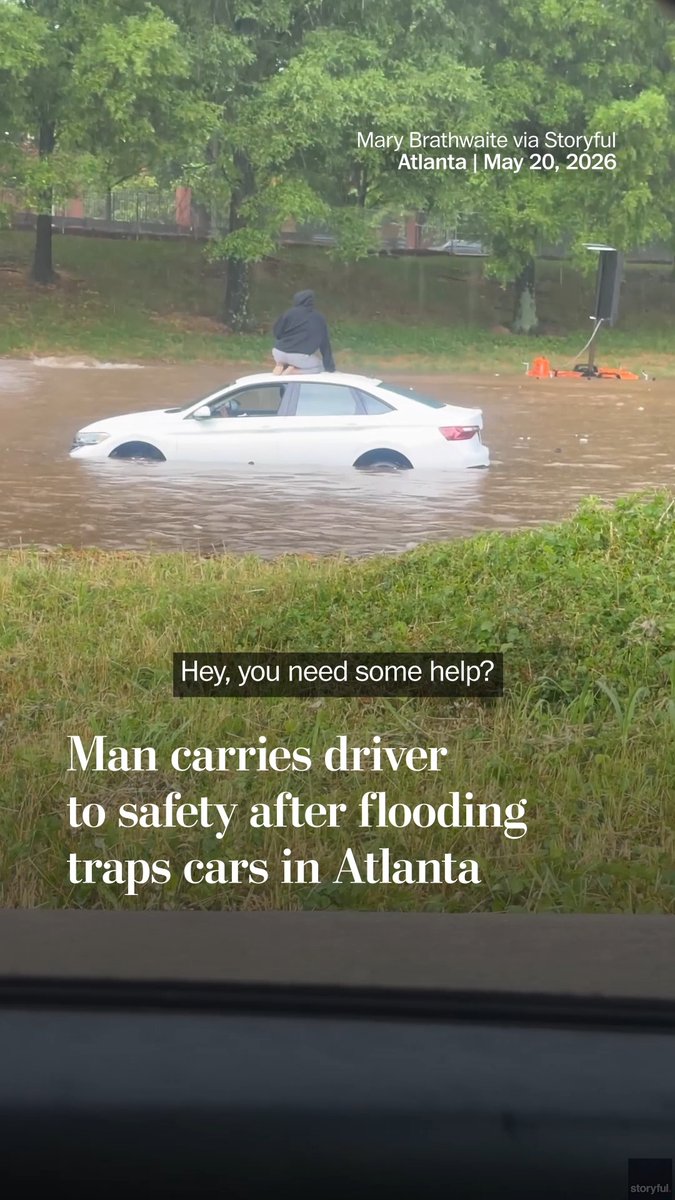 Severe flooding from heavy rain in Atlanta filled streets with water, stranding cars. A man was recorded helping a driver to safety who had become trapped on top of her car in the floodwater on May 20.