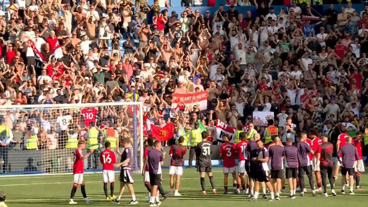 Manchester United players applaud the away end, whilst Brighton fans and players await confirmation on what European competition they will play in next season
