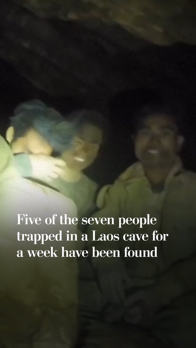 Five villagers who became trapped in a flooded cave in central Laos more than a week ago have been found alive by divers who discovered them sitting on a rock in the darkness, rescuers said. The search will continue as two others remain missing.