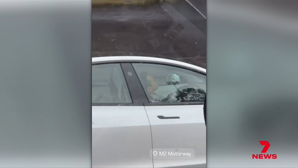 A video of a driver appearing to fall asleep behind the wheel of a self driving car on Sydney's M2 Motorway has gone viral, leaving viewers shocked. It's also raising concerns about how safe autonomous cars really are on cruise control, but there's nothing cruisy about this.