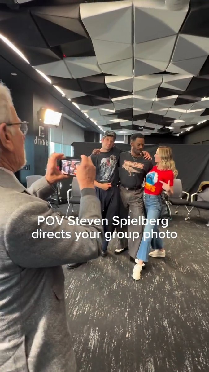 Steven Spielberg takes a picture of his ‘DISCLOSURE DAY’ cast wearing shirts of his movies.