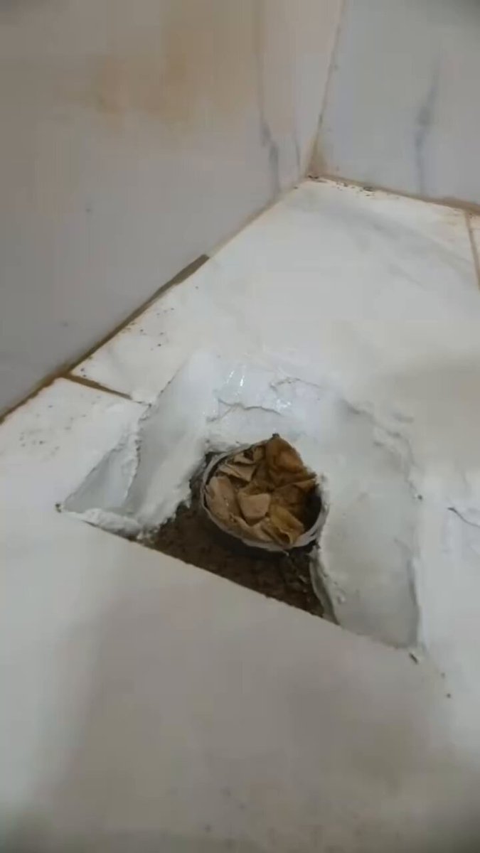 Installing a bathroom drain inlet.