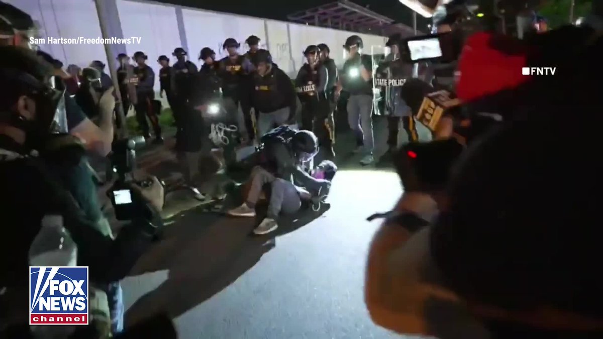NEW: Agitator wrestled to the ground by New Jersey State Police as officers move in to enforce a curfew outside Newark's Delaney Hall detention center. More than a dozen arrests have been made following days of escalating tensions around the ICE facility. Authorities say weekend clashes between rioters and law enforcement included burning tires, thrown projectiles, and confrontations that prompted an increased police presence. DHS sent a blunt warning to the agitators: "If you riot, you will face the consequences. Law and order prevails."
