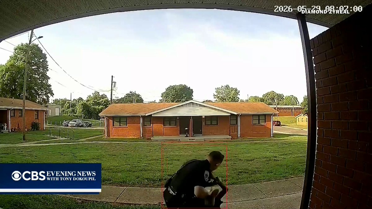 A former North Carolina police officer who was fired over the weekend turned himself in Monday to face a charge in an excessive force investigation after video showed him repeatedly punching a woman during an arrest.