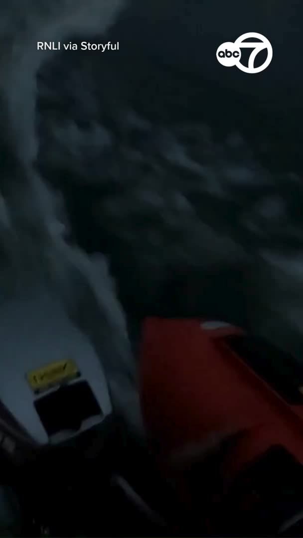RNLI volunteers rescued a paddleboarder and a dog stranded at the base of a cliff in Cemaes, Wales, as severe weather swept through the area on May 27.