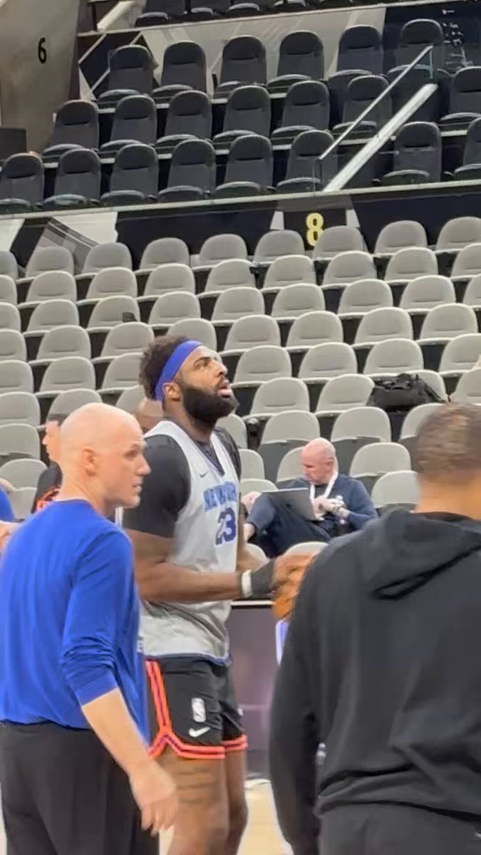 Mitchell Robinson shooting around with a wrap on his right hand.