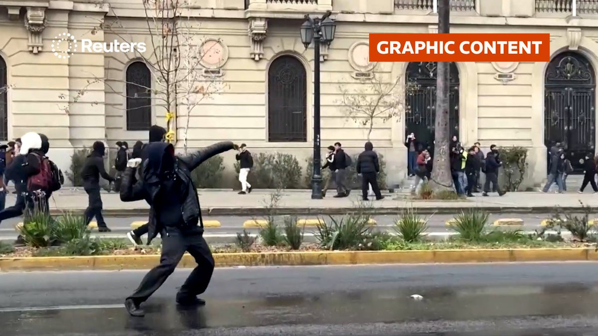 WARNING: GRAPHIC CONTENT At least one student was injured and carried away by police during clashes at a national strike in Santiago