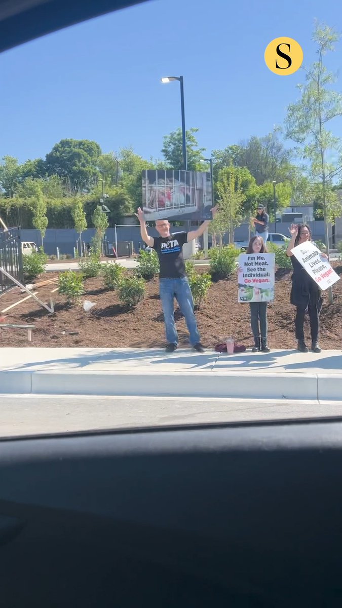 Yards away from the grand opening ceremony of Raising Cane’s in Owings Mills, animal rights activists held what they described as a “somber vigil” in protest of the new fried chicken chain outpost. On Wednesday morning, representatives of the nonprofit organization People for the Ethical Treatment of Animals (PETA) gathered outside the new Owings Mills Raising Cane’s, at 10231 Reisterstown Road. The group held signs denouncing the brand and featuring photographs of dejected chickens in cages, and passed out “vegan starter kits” with literature and advice on observing a plant-based diet. “Raising Cane’s makes a big to-do about these opening day celebrations,” PETA volunteer organizer David Salisbury said. “I think if most people knew what happened in these houses of horror, they would ditch the chicken fast-food bag and join us out here.” Read more: 🎥: Caleb Townsend, The Baltimore Sun