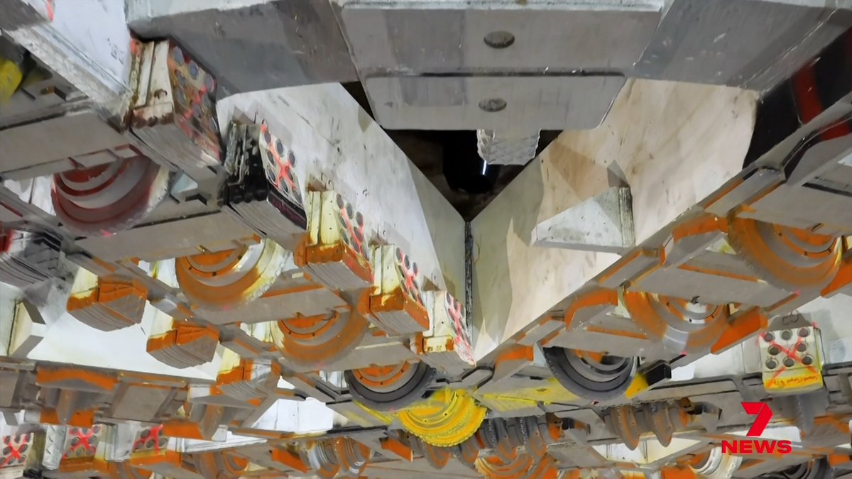 A massive boring machine, the biggest ever assembled underground, is about to start chewing its way beneath Sydney Harbour.