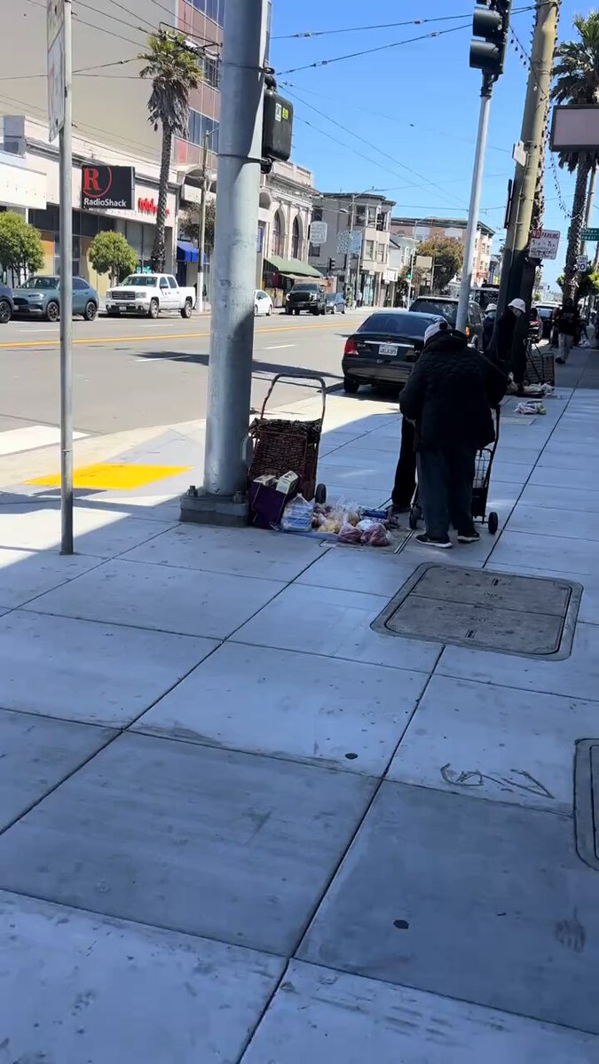 DISGUSTING. San Francisco food banks hand out FREE taxpayer-funded groceries to the homeless… and they immediately dump it on the sidewalk to SELL for $1 each. While working families get crushed by taxes and inflation, this is what “compassion” looks like in a failing blue hellhole. Your money. Their sidewalk flea market. When does this insanity end? 🇺🇸