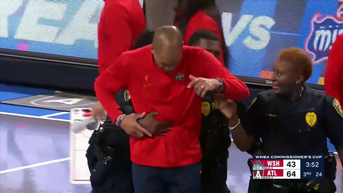 Washington Mystics' head coach Sydney Johnson was escorted off the court after this interaction with the officials.