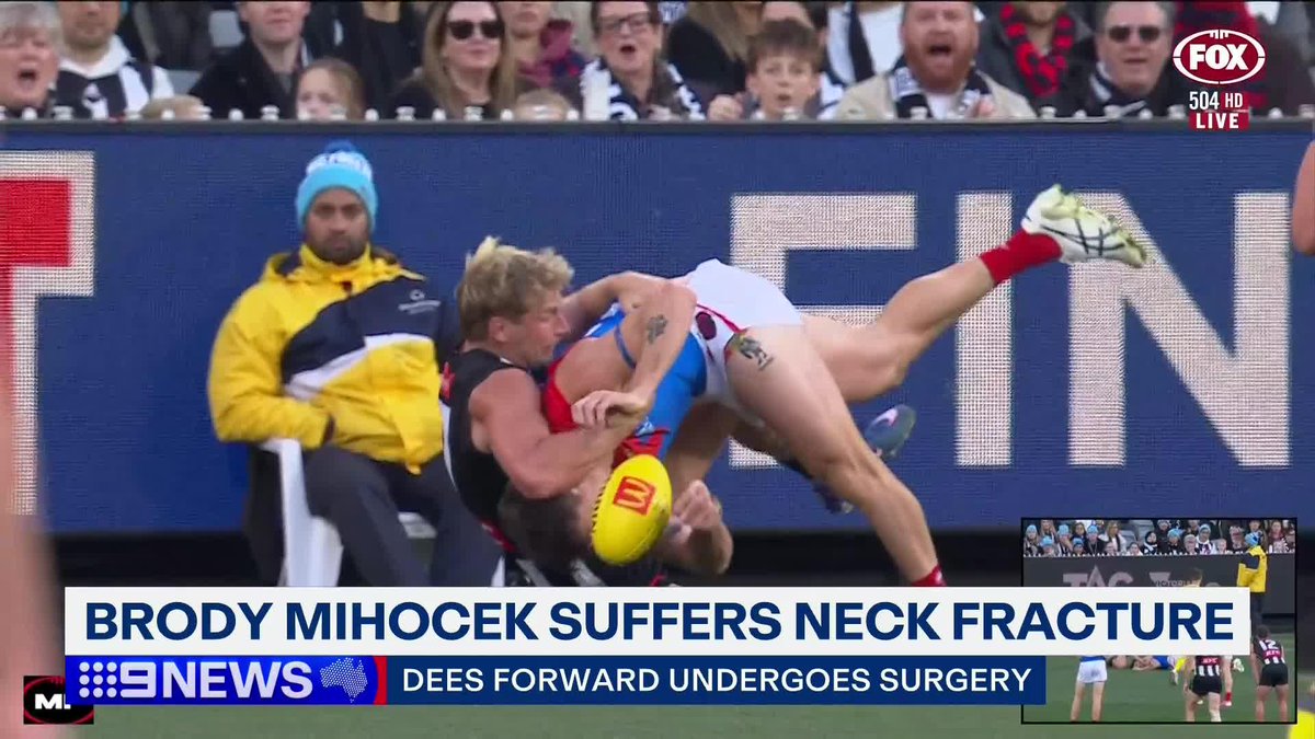 Melbourne's Brody Mihocek remains in hospital after suffering a neck fracture against his old side, Collingwood, at the MCG. Trent Kniese #9News