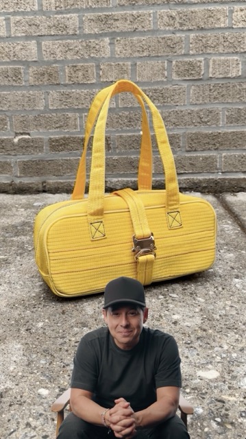 I tell stories about entrepreneurs. Nik Bentel tells stories through objects he creates. When we asked Nik to design something with us, he looked at an item that touches nearly every entrepreneur's product but almost no one thinks twice about: the yellow shipping strap. Then he turned it into a handbag.